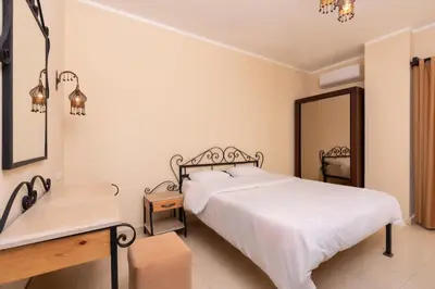 a bedroom with a bed and a desk and a mirror at 2bedrooms apartment 53 in Hurghada