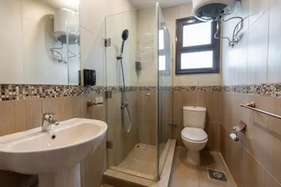 a bathroom with a sink and a toilet and a shower at 2bedrooms apartment 53 in Hurghada