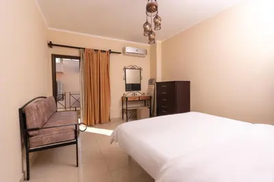 a bedroom with a bed and a chair and a desk at 2bedrooms apartment 53 in Hurghada