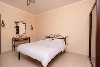a bedroom with a white bed and a mirror at 2bedrooms apartment 53 in Hurghada