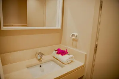 a bathroom with a sink and a towel at Modern apartment with large pool & beach access in Hurghada
