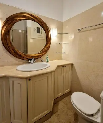 a bathroom with a sink and a mirror at Nubian Style Apartment, South Marina, El Gouna in Hurghada