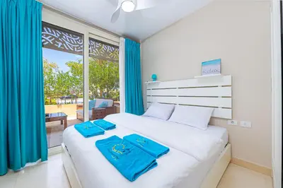 a bedroom with a bed with blue towels on it at Modern apartment with great Pool & Beach access in Hurghada