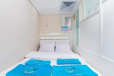 a bed in a room with blue towels on it at Modern apartment with great Pool & Beach access in Hurghada