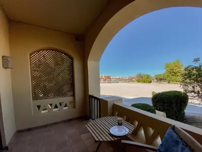 a balcony with a table and a window at Style Apartment in nubian design at lagoon in Hurghada