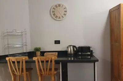 a kitchen with a counter with a clock on the wall at Hurghada Cosy Apart in Hurghada
