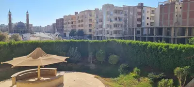 an umbrella sitting on a bench in a city at Hurghada Cosy Apart in Hurghada