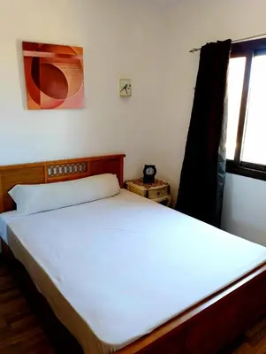 a bedroom with a white bed with a window at Шале Stella di mare Makadi Хургада in Hurghada