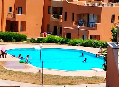 a group of people playing in a swimming pool at Шале Stella di mare Makadi Хургада in Hurghada