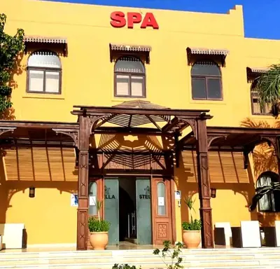 a yellow building with an entrance to a spa at Шале Stella di mare Makadi Хургада in Hurghada