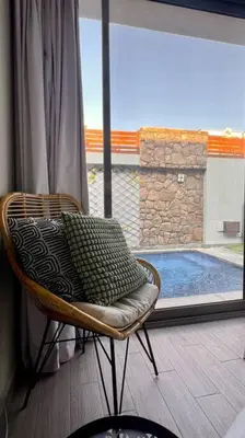 a chair with a pillow in front of a window at 1BR villa - private heated pool in Bali ElGouna in Hurghada
