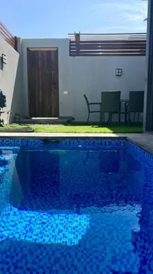 a swimming pool with blue tiles in a yard at 1BR villa - private heated pool in Bali ElGouna in Hurghada