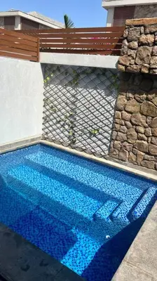 a swimming pool with blue water in front of a building at 1BR villa - private heated pool in Bali ElGouna in Hurghada