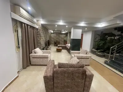 a living room with couches and chairs in a room at Hurghada-Magawish Villa 4 in Hurghada