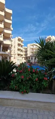 a view of a building with flowers and plants at Ubytovani v novém resortu Aqua Tropical poblíž El Gouny in Hurghada
