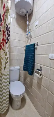 a bathroom with a toilet and a blue towel at Ubytovani v novém resortu Aqua Tropical poblíž El Gouny in Hurghada