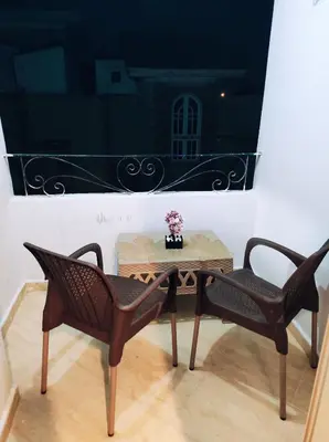 a table and two chairs in a room at Oriental Tail Home in Hurghada
