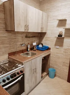 a kitchen with a sink and a stove at Oriental Tail Home in Hurghada