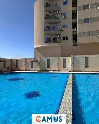 a large swimming pool in front of a building at CAMUS 343, Princess Resort in Hurghada