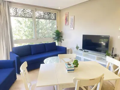 a living room with a blue couch and a table at El Gouna Mangroovy 1-Bedroom Sleeps 4-Persons, M8-4C-14 in El Gouna