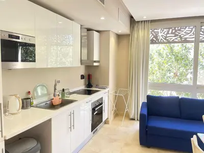 a kitchen with a sink and a blue couch at El Gouna Mangroovy 1-Bedroom Sleeps 4-Persons, M8-4C-14 in El Gouna