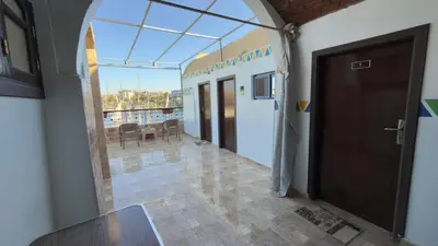 a hallway with a glass door and a dining room at Bakar Nubian Guest House in Aswan
