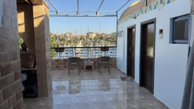 a patio with chairs and a table on a balcony at Bakar Nubian Guest House in Aswan