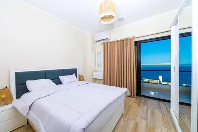 a bedroom with a large bed and a large window at Felfela View in Hurghada