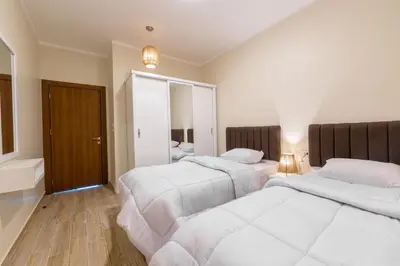 a hotel room with two beds and a mirror at Felfela View in Hurghada