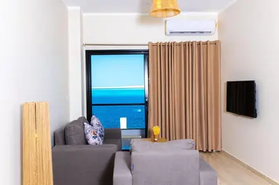 a living room with a couch and a large window at Felfela View in Hurghada
