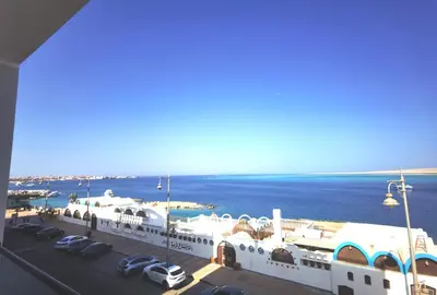 a view of a large white building next to the water at Felfela View in Hurghada
