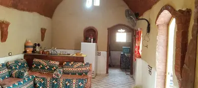 a living room with two couches and a refrigerator at Mountain View House in ‘Ezbet Abu Ḥabashi