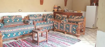 a living room with two couches and a table at Mountain View House in ‘Ezbet Abu Ḥabashi