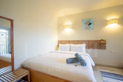 a bed with a pair of jeans sitting on it at Ladybird - Veranda Beach House in Hurghada