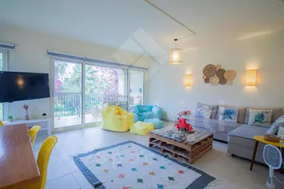 a living room with a couch and a table at Ladybird - Veranda Beach House in Hurghada