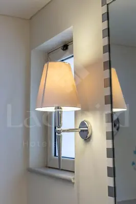 a lamp on a door with a window at Ladybird - Veranda Beach House in Hurghada