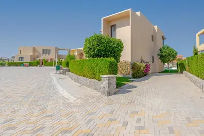 a villa with a hedge in front of a house at Elegant 4BR in Tawila, Gouna. Private Pool, Lagoon in Hurghada