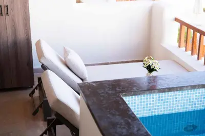 a dining room with a table and a swimming pool at Makadi Heights Elite Worldwide Residences - Hurghada, Egypt in Hurghada