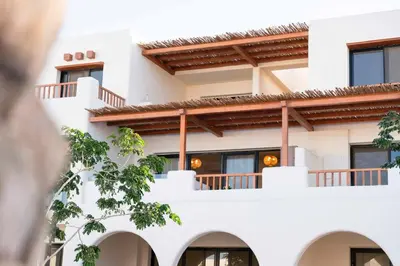 a white building with windows and balconies at Makadi Heights Elite Worldwide Residences - Hurghada, Egypt in Hurghada
