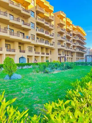 a large apartment building with a green yard at Luna Blu Sea View in Hurghada