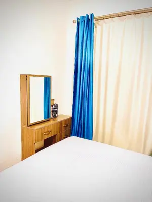 a bedroom with a bed with a mirror and a blue curtain at Luna Blu Sea View in Hurghada