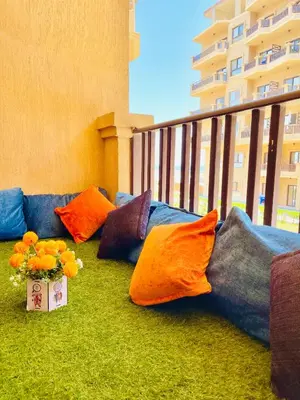 a balcony with pillows and flowers on the floor at Luna Blu Sea View in Hurghada