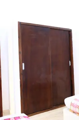 a brown sliding door in a room with a bed at Magic Place Luxor in Luxor