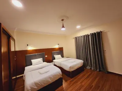 a hotel room with two beds and a window at Wa set Luxor Apartment in Luxor