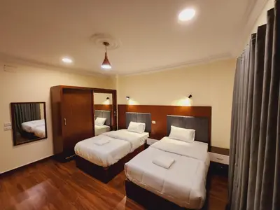 a hotel room with two beds and a mirror at Wa set Luxor Apartment in Luxor