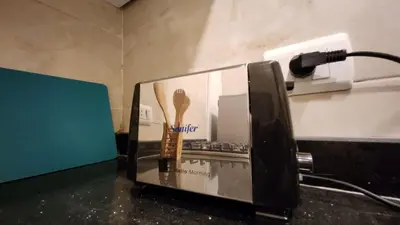 a phone sitting on a counter next to a toaster at Wa set Luxor Apartment in Luxor
