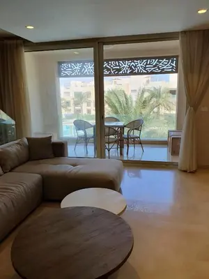 a living room with a couch and a table at Mangroovy 2BR with roof in Hurghada