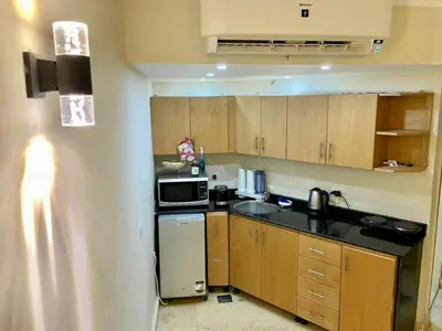 a small kitchen with a stove and a microwave at Top floor premier view chalet in Red sea Hurghada in Hurghada