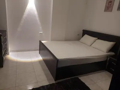 a small bedroom with a bed with white sheets at one bed Apartment In Al Makramia in Hurghada