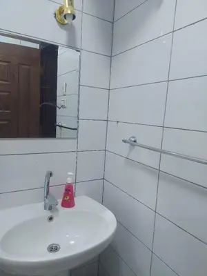 a white bathroom with a sink and a mirror at one bed Apartment In Al Makramia in Hurghada